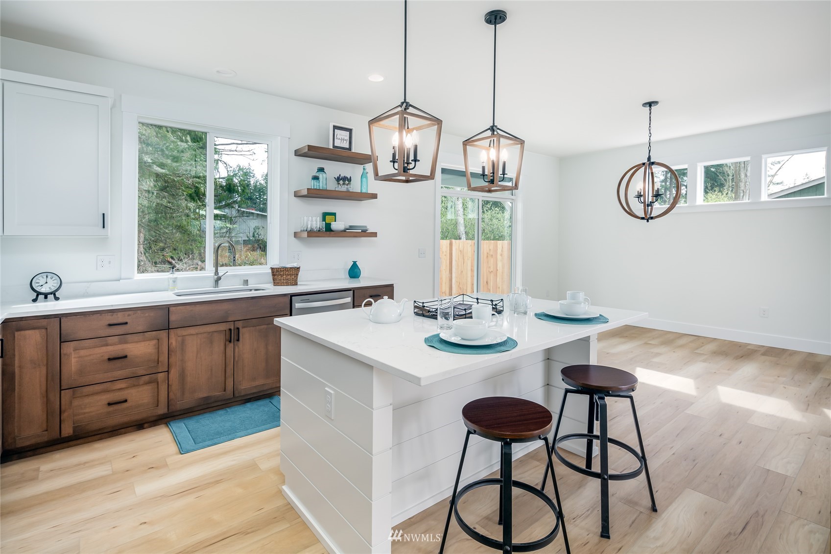 2284 South 19th Street Mount Vernon, WA 98274 - Photo 20 of 29 a open dining room with wooden floor a chandelier a wooden table and chairs