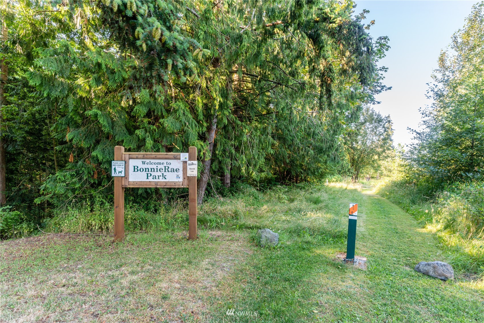 2284 South 19th Street Mount Vernon, WA 98274 - Photo 10 of 29 a sign that is sitting in the grass near a tree