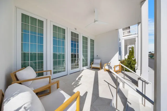 a living room with furniture fireplace and a large window