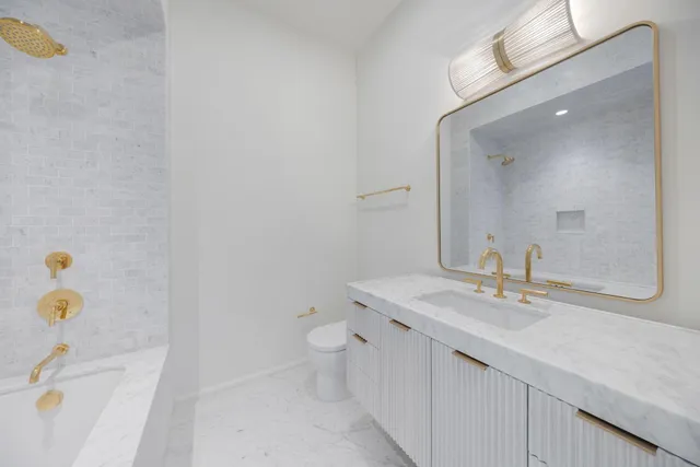 a view of a white building among the street with palm trees