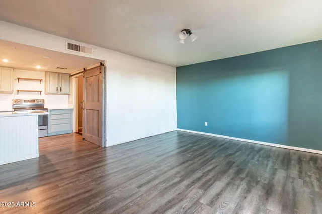 a kitchen with a refrigerator and a stove