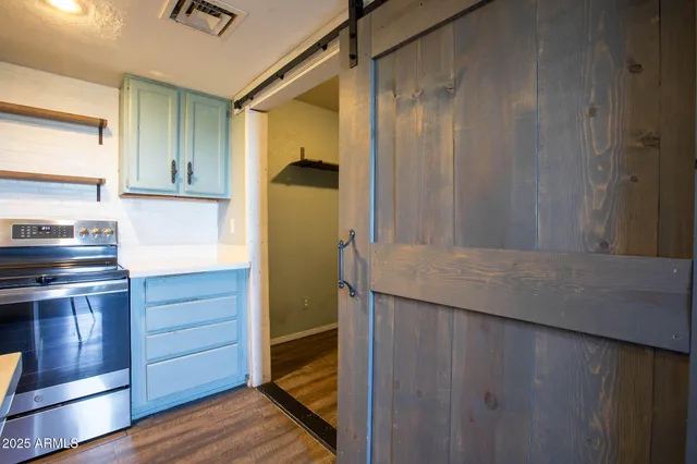 a kitchen with a sink and wooden floor