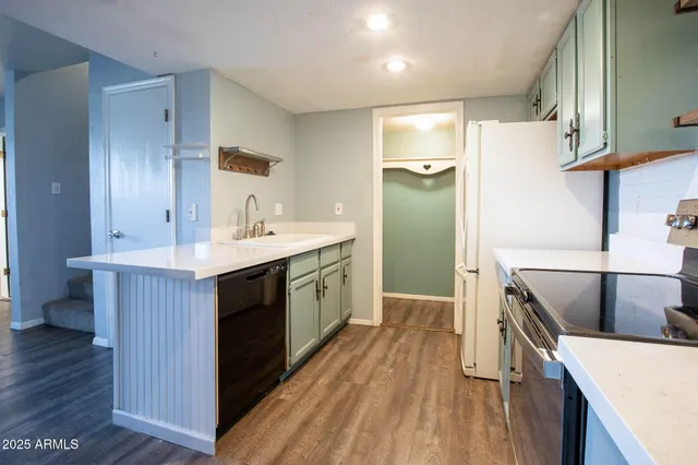 a kitchen with a stove and a refrigerator