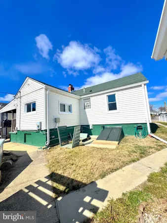 a view of a white house with a yard