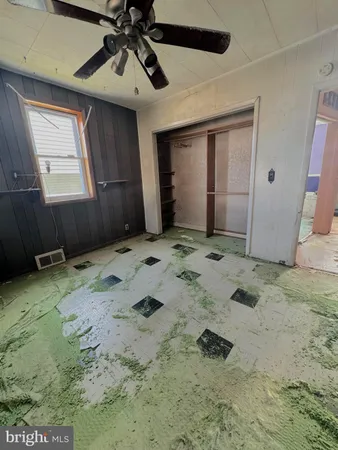 a view of a livingroom with wooden floor and window