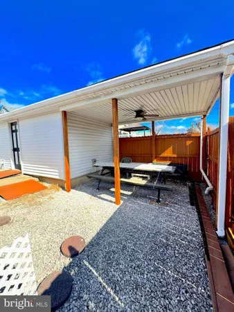 a backyard of a house with barbeque oven table and chairs