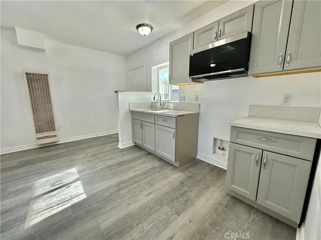 a kitchen with a sink and a stove top oven