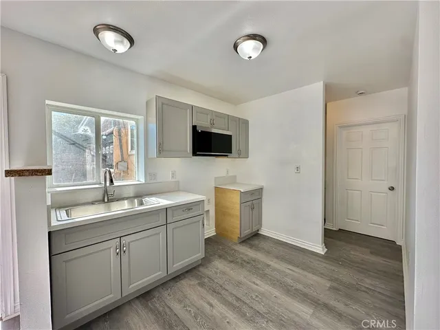 a spacious bathroom with a double vanity sink a mirror and a bathtub