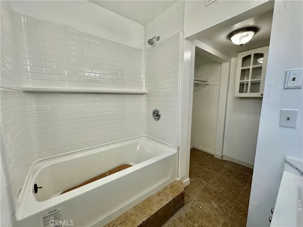 a bathroom with a tub and a shower