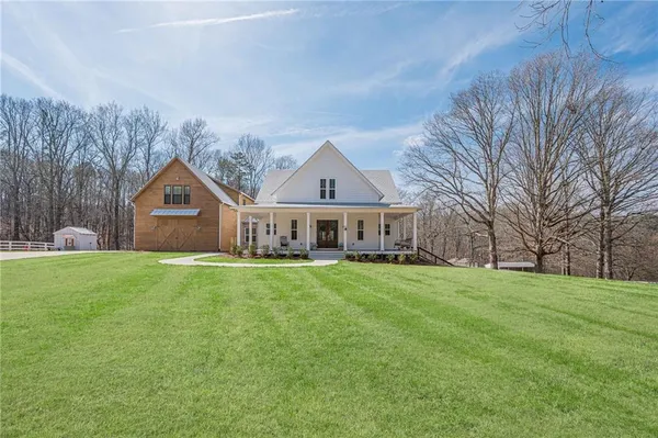 a front view of house with yard and trees
