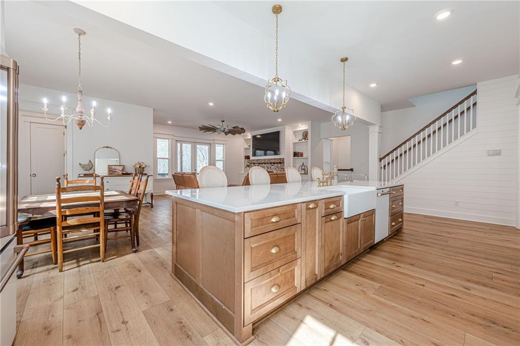312 Ball Field Road Waleska, GA 30183 - Photo 14 of 73 a large kitchen with kitchen island a sink a center island a stove and a chandelier