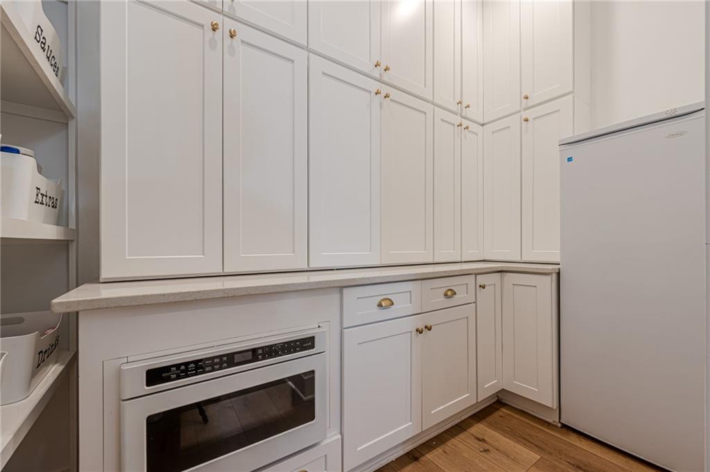 312 Ball Field Road Waleska, GA 30183 - Photo 17 of 73 a view of a kitchen with white cabinets and white appliances
