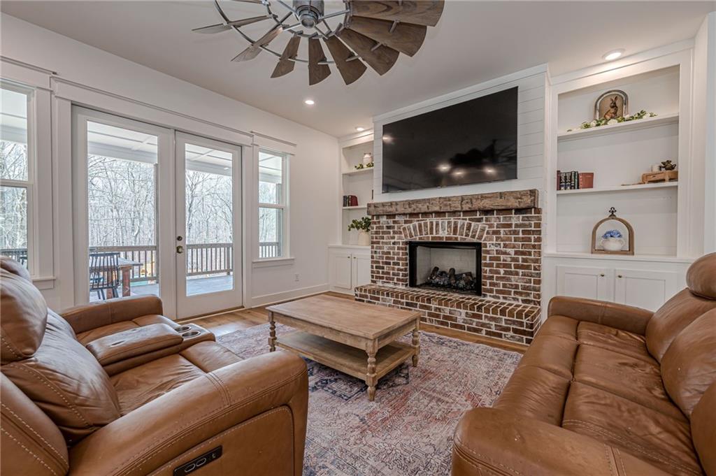 312 Ball Field Road Waleska, GA 30183 - Photo 20 of 73 a living room with furniture a flat screen tv and a fireplace