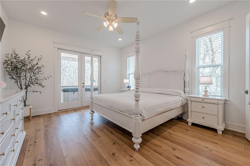 312 Ball Field Road Waleska, GA 30183 - Photo 28 of 73 a bedroom with a large bed and a chandelier