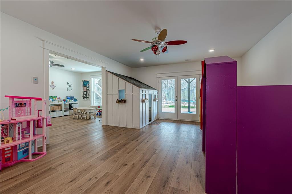 312 Ball Field Road Waleska, GA 30183 - Photo 44 of 73 a view of a livingroom with wooden floor and a ceiling fan