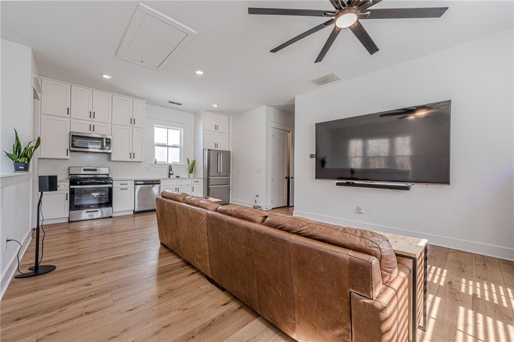312 Ball Field Road Waleska, GA 30183 - Photo 54 of 73 a living room with stainless steel appliances furniture and a flat screen tv