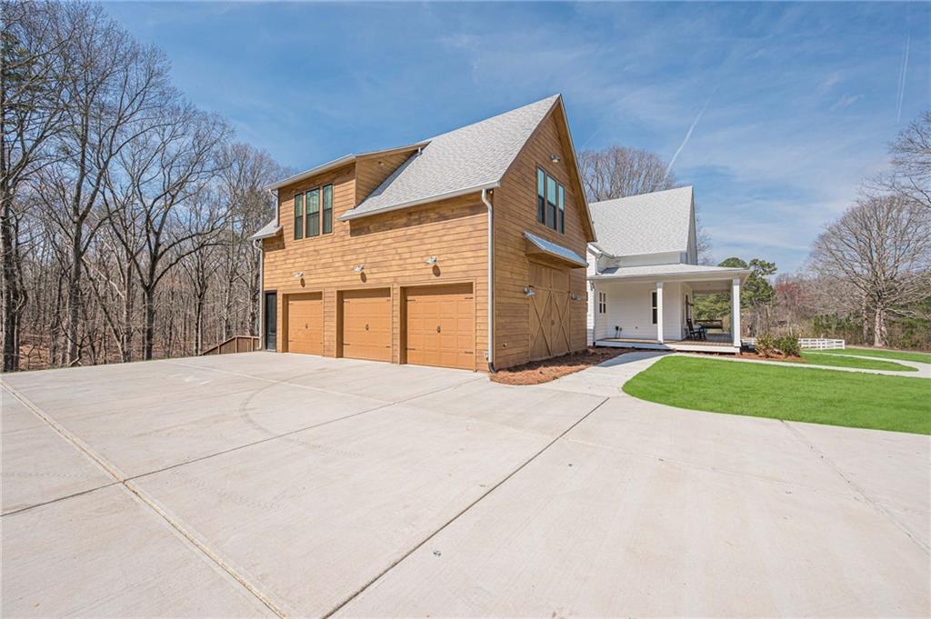 312 Ball Field Road Waleska, GA 30183 - Photo 6 of 73 a front view of a house with a yard and garage