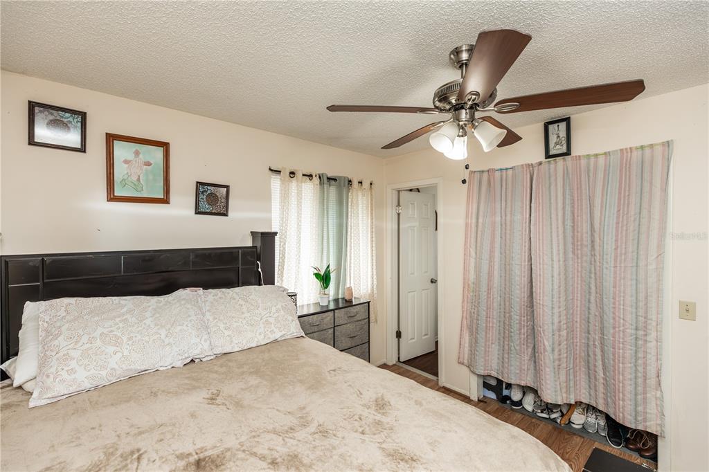 1230 8th Avenue DeLand, FL 32724 - Photo 17 of 25 a bedroom with a large bed and a chandelier
