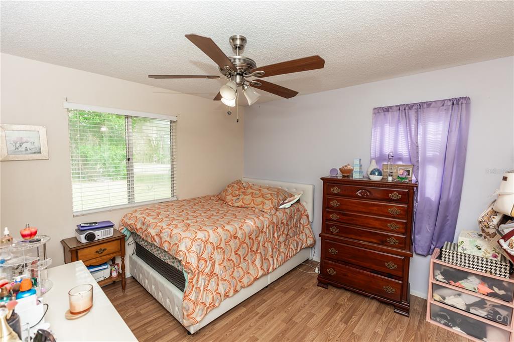 1230 8th Avenue DeLand, FL 32724 - Photo 20 of 25 a bedroom with a bed and a chandelier
