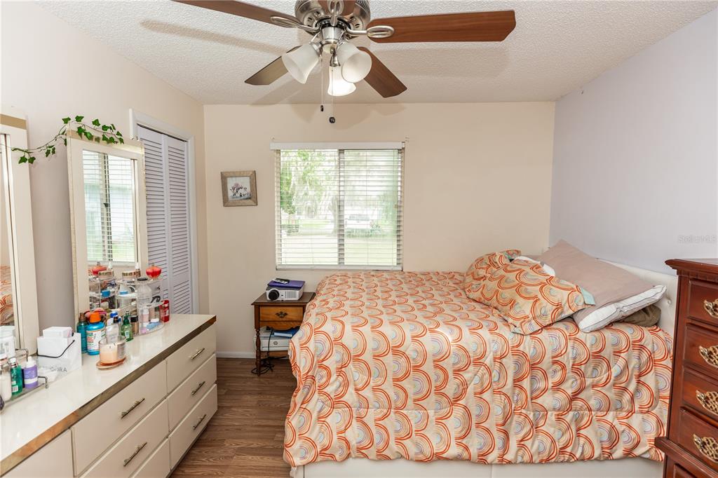 1230 8th Avenue DeLand, FL 32724 - Photo 21 of 25 a bedroom with a bed and a chandelier