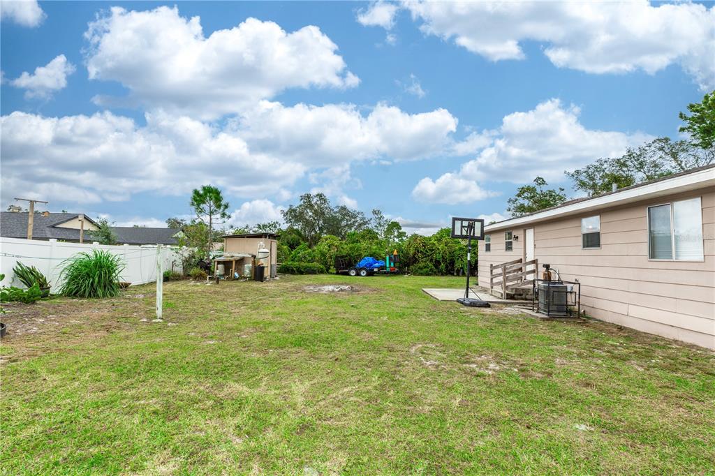 1230 8th Avenue DeLand, FL 32724 - Photo 25 of 25 a backyard of a house with table and chairs