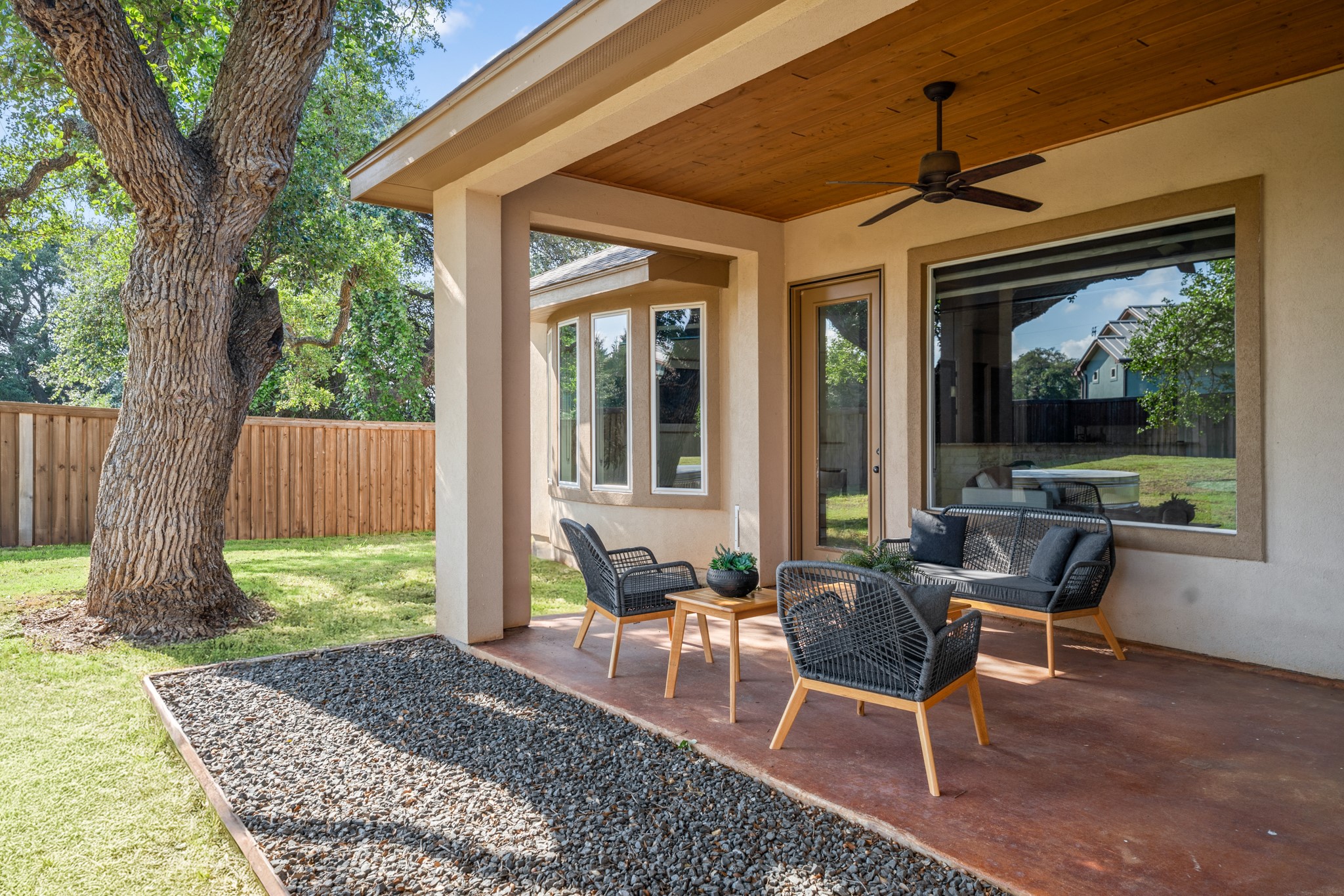 128 Hiram Cook Blanco, TX 78606 - Photo 29 of 40 Covered patio featuring a wood-finish ceiling with a ceiling fan, a private backyard with a wooden fence, a manicured lawn, and a mature tree