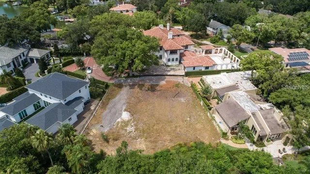 an aerial view of a house with yard swimming pool and outdoor seating