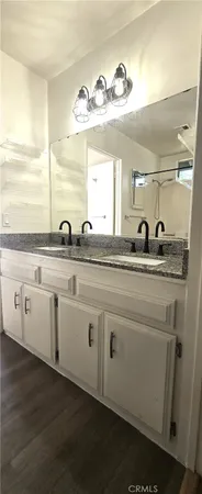 a bathroom with a double vanity sink and a mirror