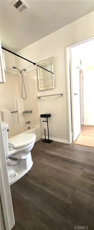 a bathroom with a toilet a sink and a shower