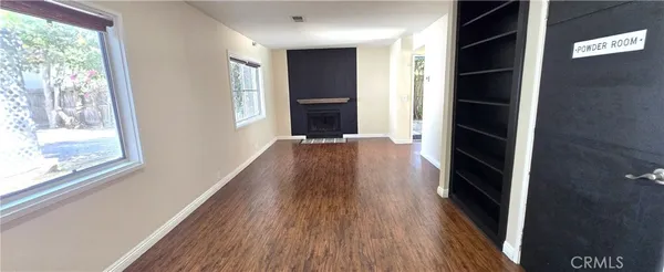 a view of hallway with wooden floor and window
