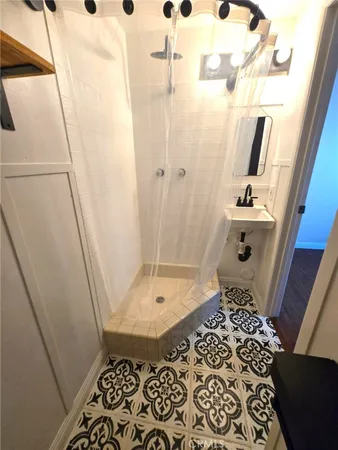 a bathroom with a sink and mirror with toilet