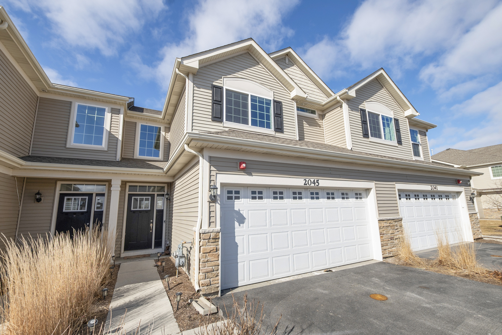 a view of a house with a garage and balcony