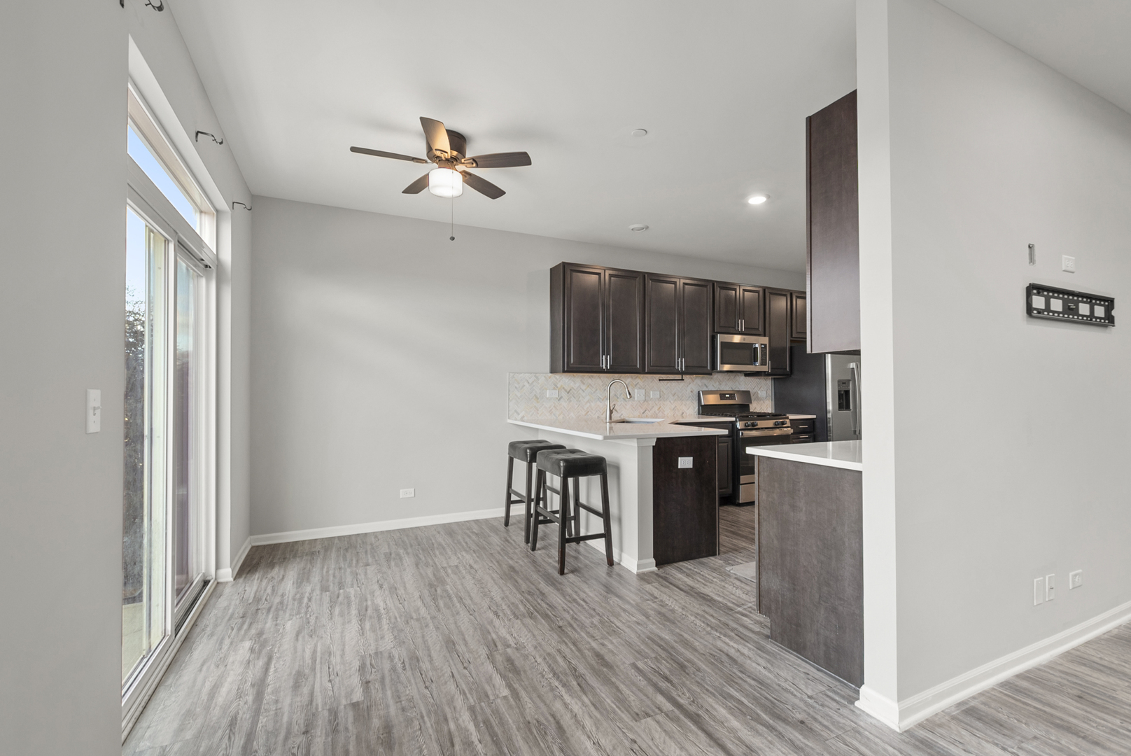 2045 Stuttle Road Batavia, IL 60510 - Photo 4 of 18 a kitchen with a refrigerator a stove top oven a sink and dishwasher with wooden floor