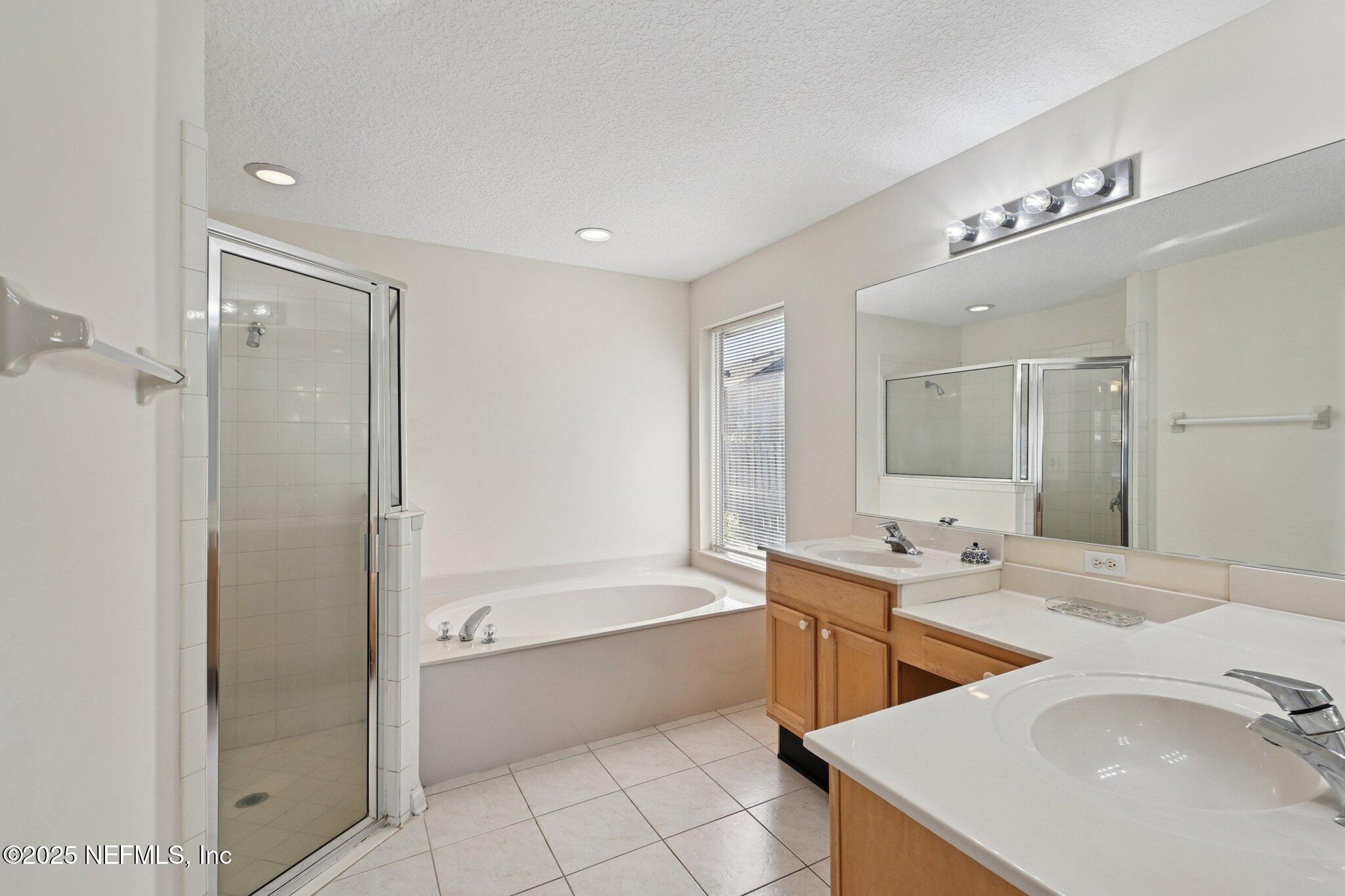 1862 Sentry Oak Court Fleming Island, FL 32003 - Photo 13 of 83 a bathroom with a tub sink double and mirror
