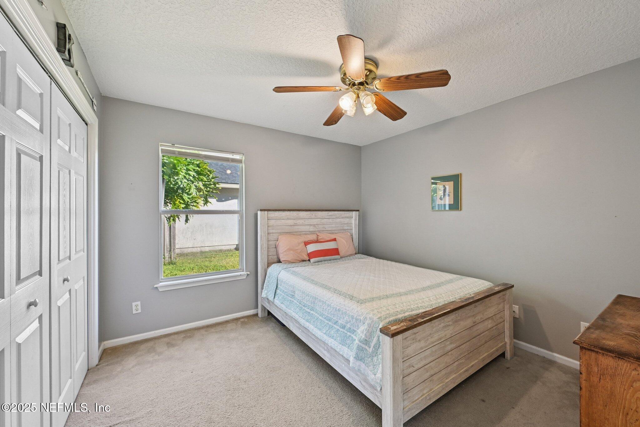 1862 Sentry Oak Court Fleming Island, FL 32003 - Photo 17 of 83 a bedroom with a bed and a window