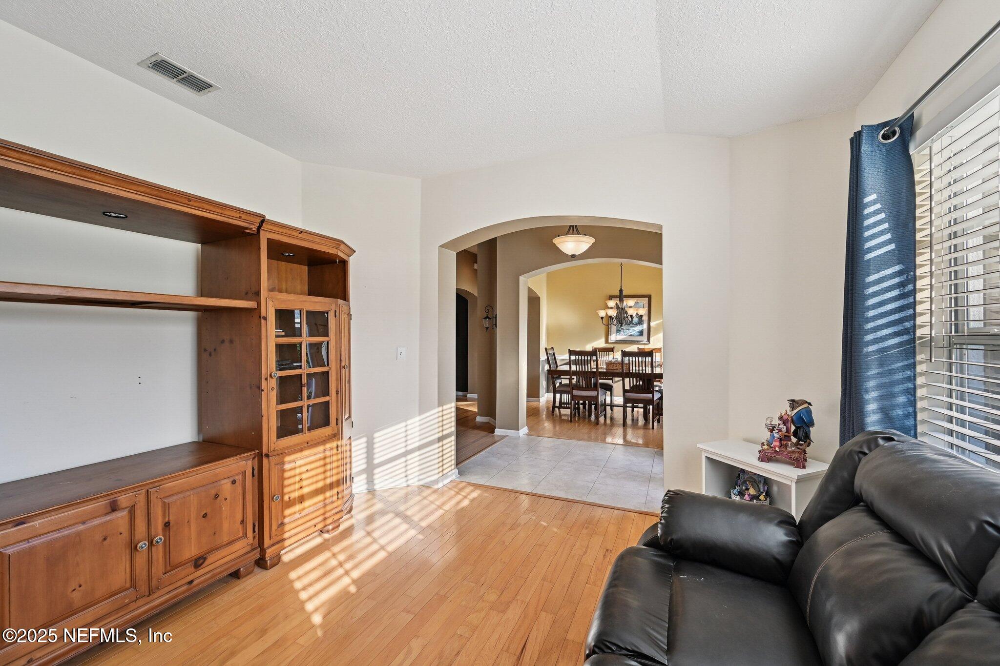1862 Sentry Oak Court Fleming Island, FL 32003 - Photo 31 of 83 a living room with furniture and wooden floor