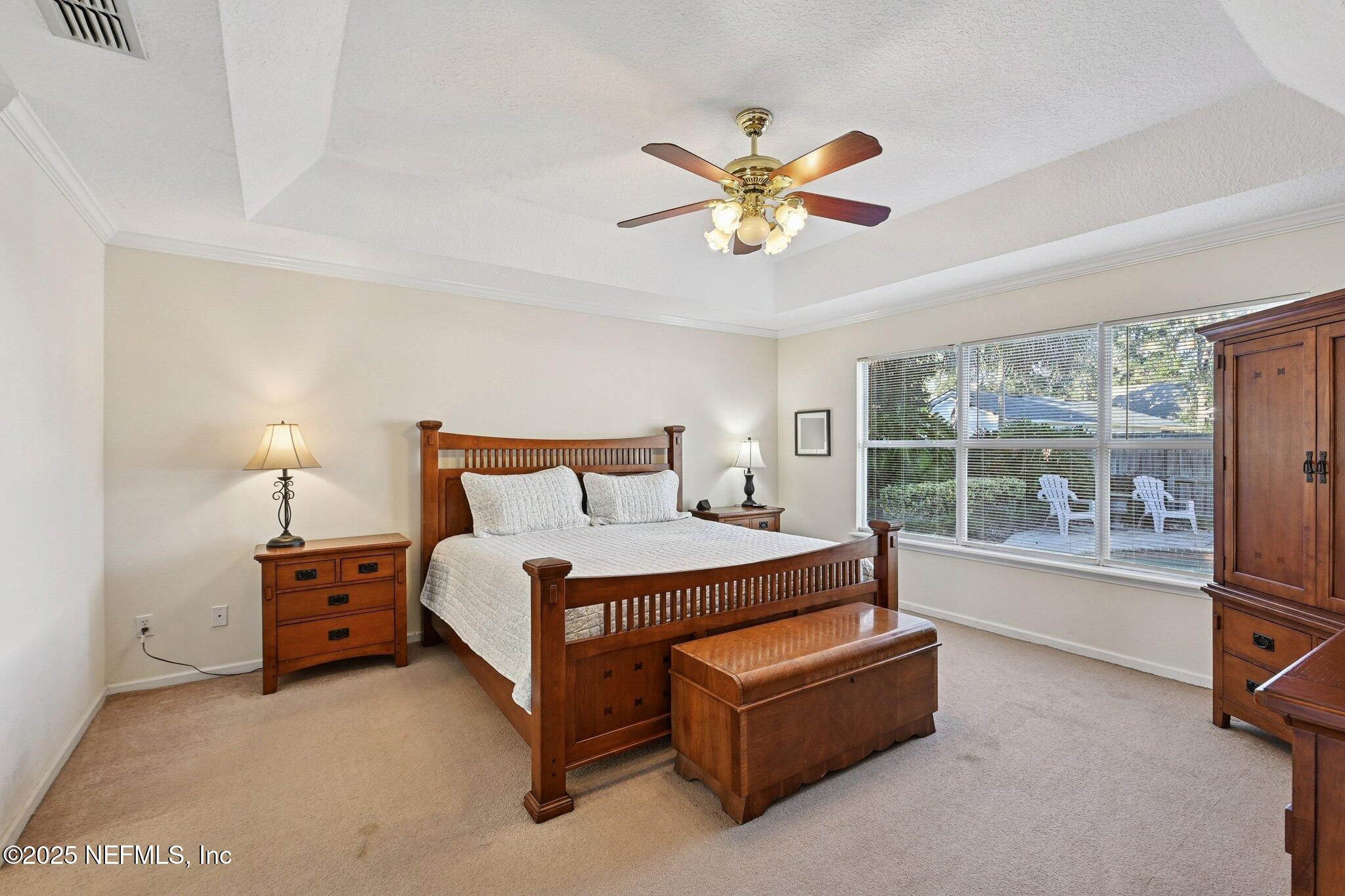 1862 Sentry Oak Court Fleming Island, FL 32003 - Photo 39 of 83 a bedroom with a bed a couch and a large window