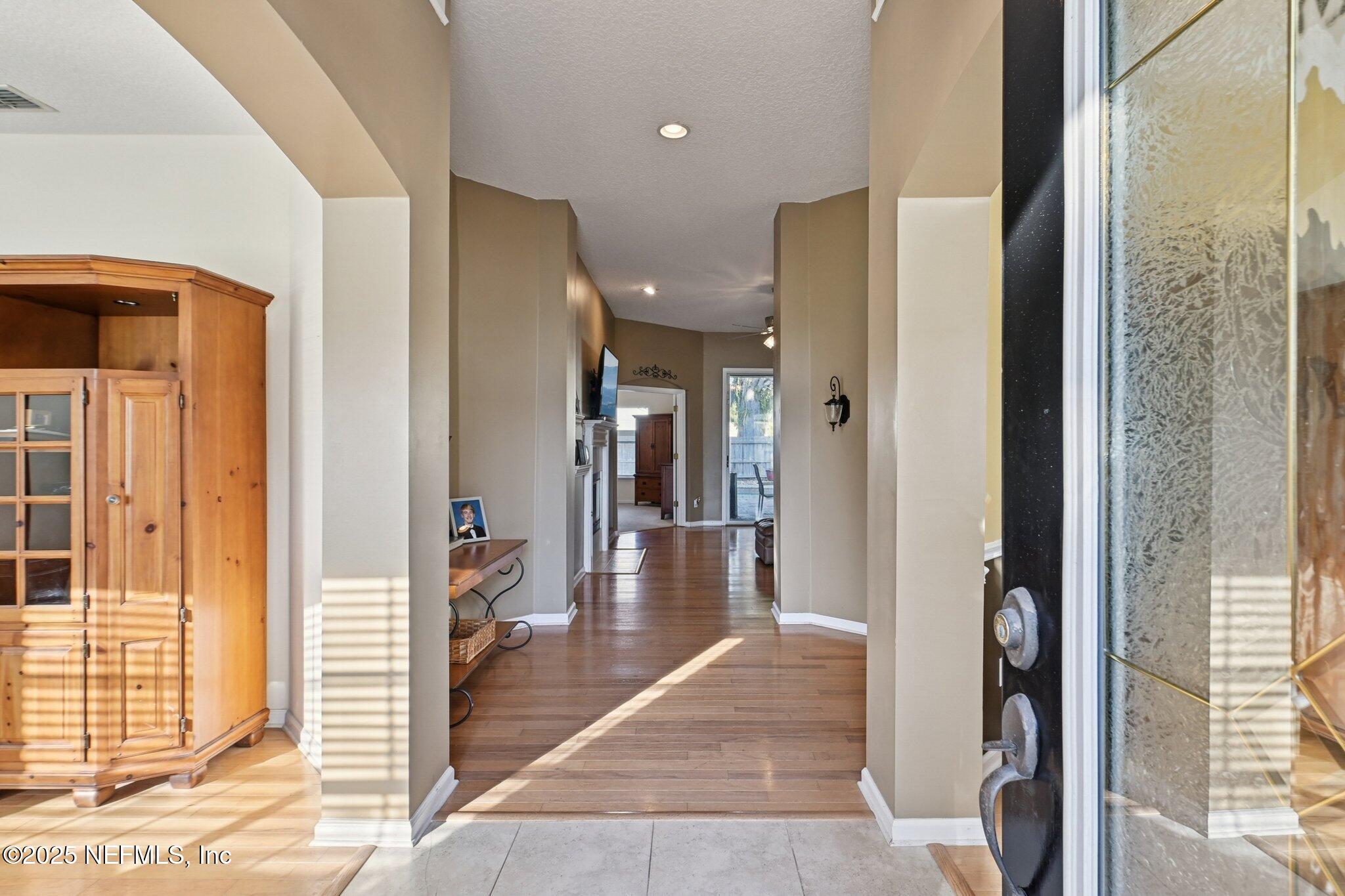 1862 Sentry Oak Court Fleming Island, FL 32003 - Photo 4 of 83 a view of a hallway with wooden floor and windows