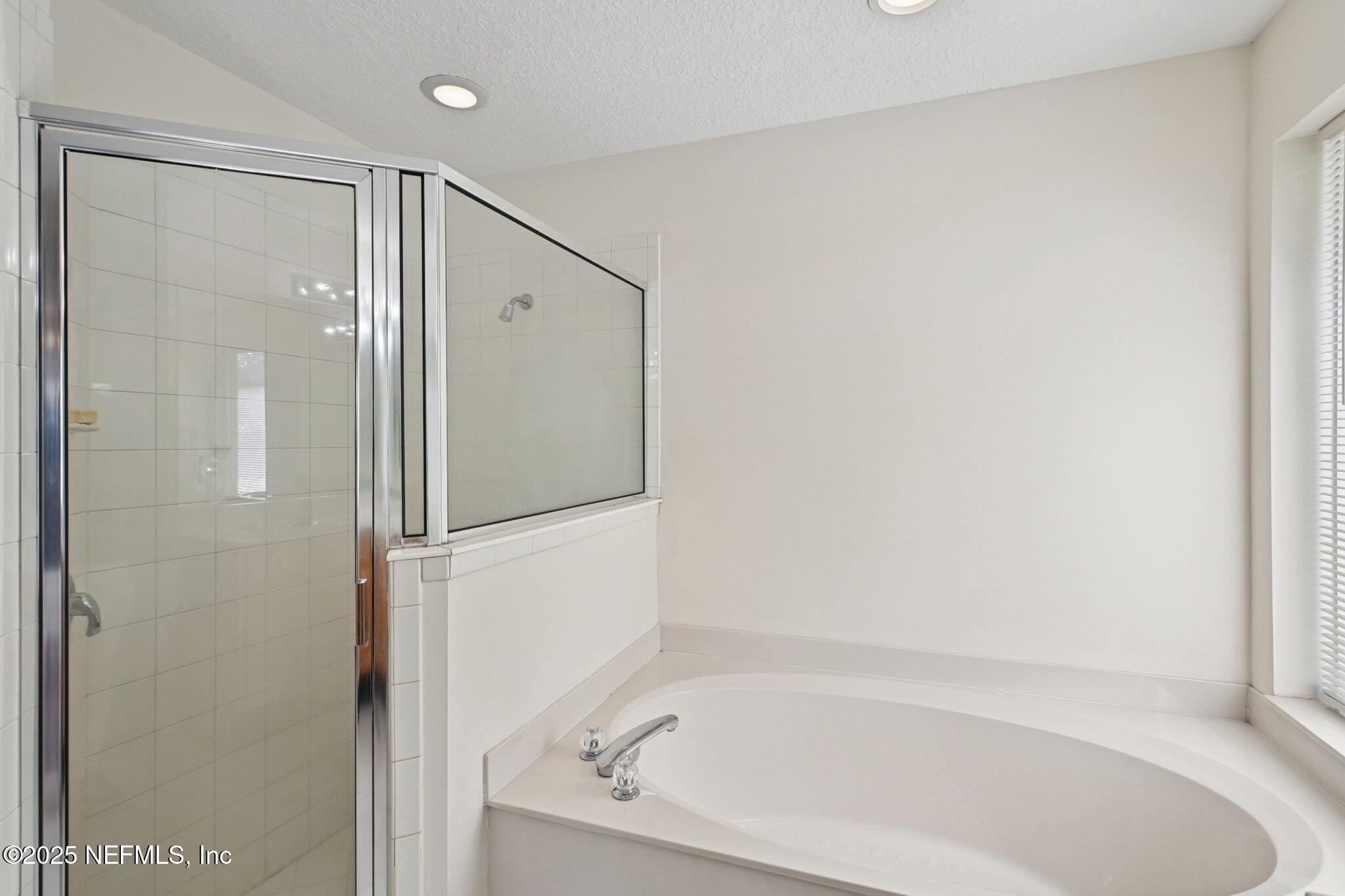 1862 Sentry Oak Court Fleming Island, FL 32003 - Photo 41 of 83 a bathroom with a bathtub and a shower