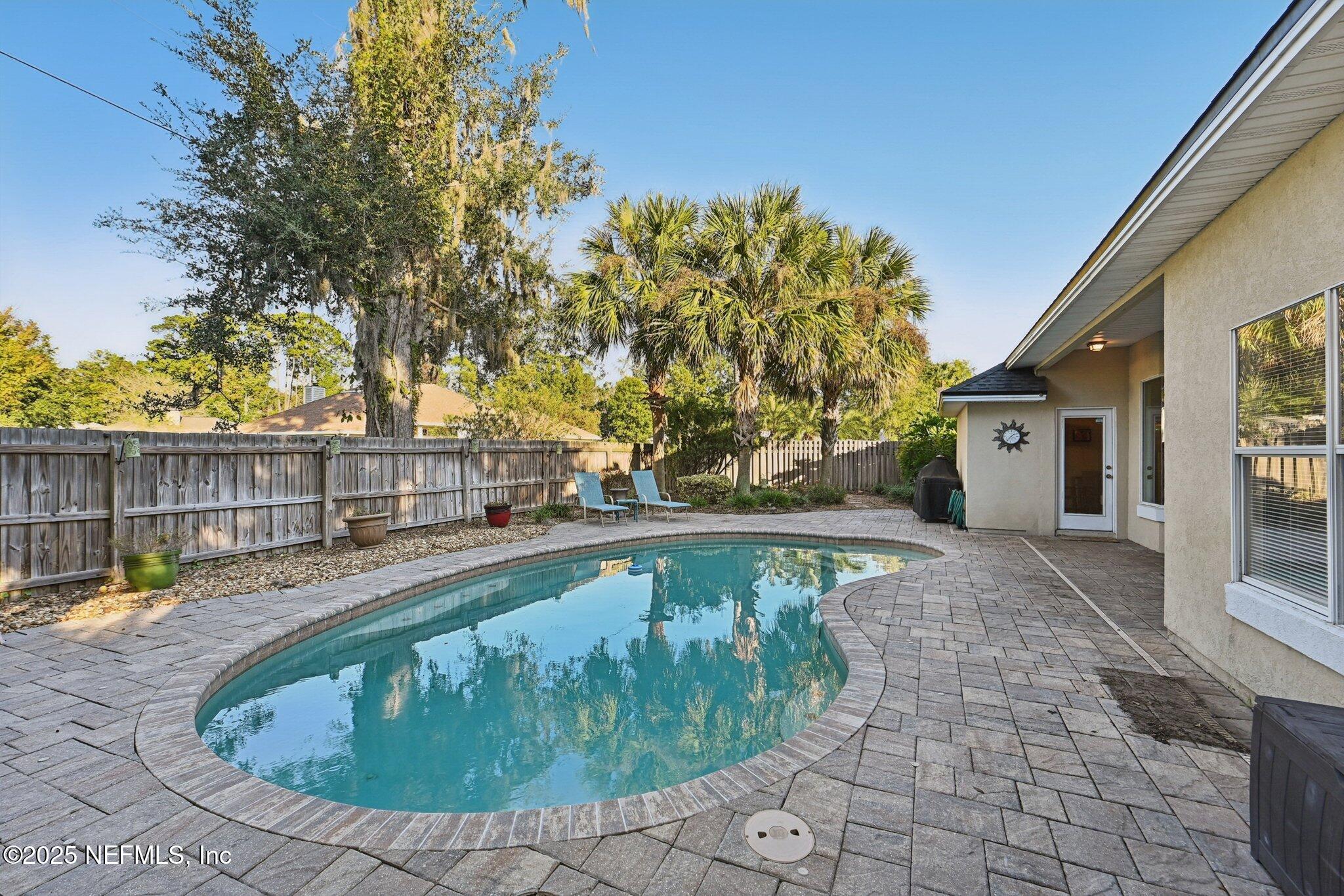 1862 Sentry Oak Court Fleming Island, FL 32003 - Photo 48 of 83 a view of a backyard with a small pool and sitting area