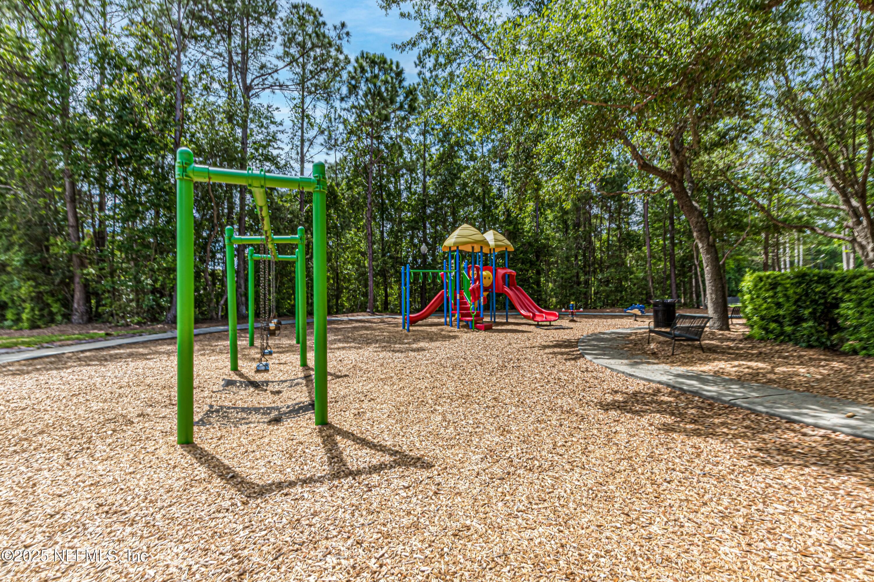 1862 Sentry Oak Court Fleming Island, FL 32003 - Photo 81 of 83 a view of a park with swings and slides