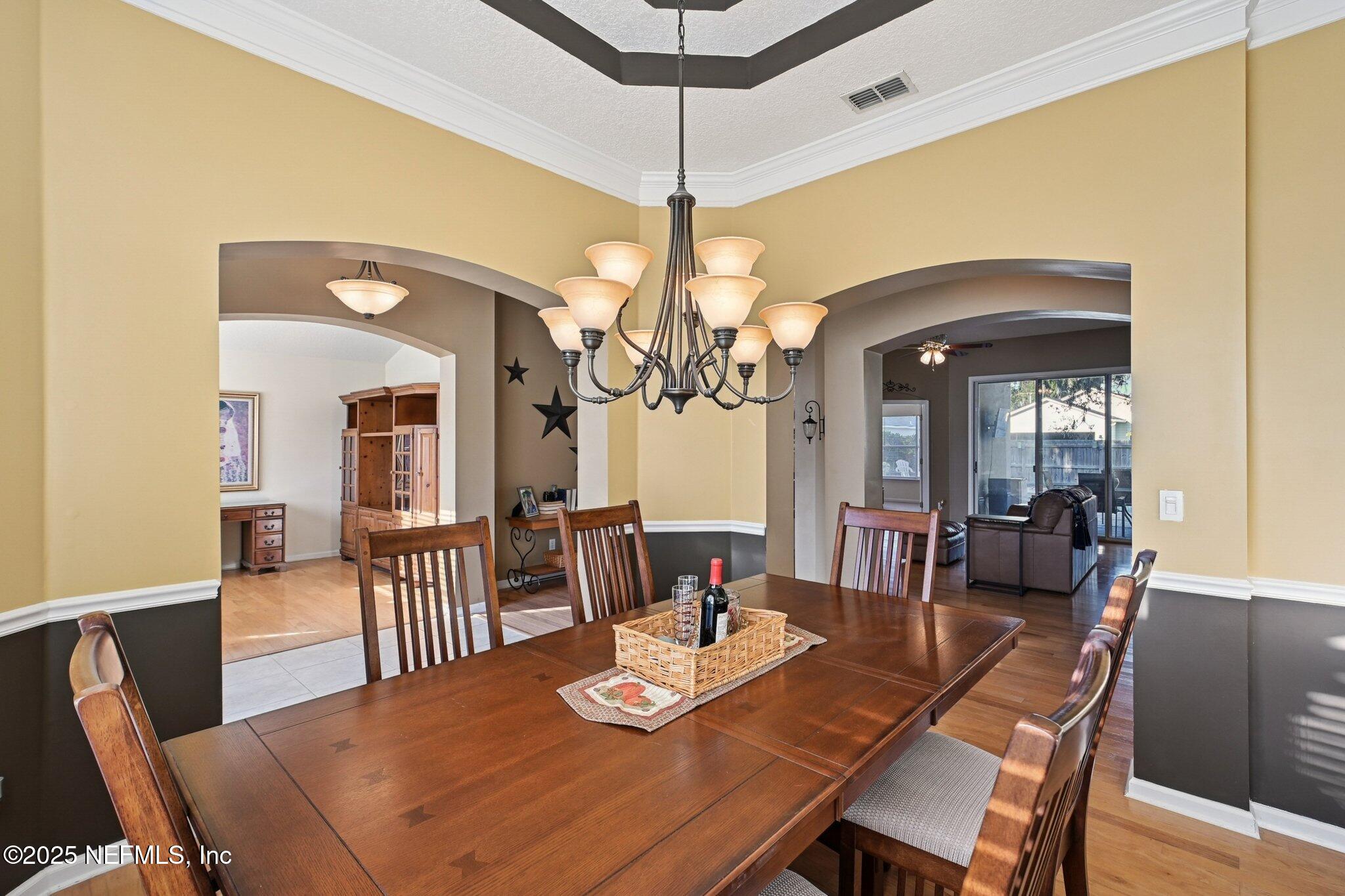 1862 Sentry Oak Court Fleming Island, FL 32003 - Photo 10 of 83 a view of a dining room with furniture and a chandelier