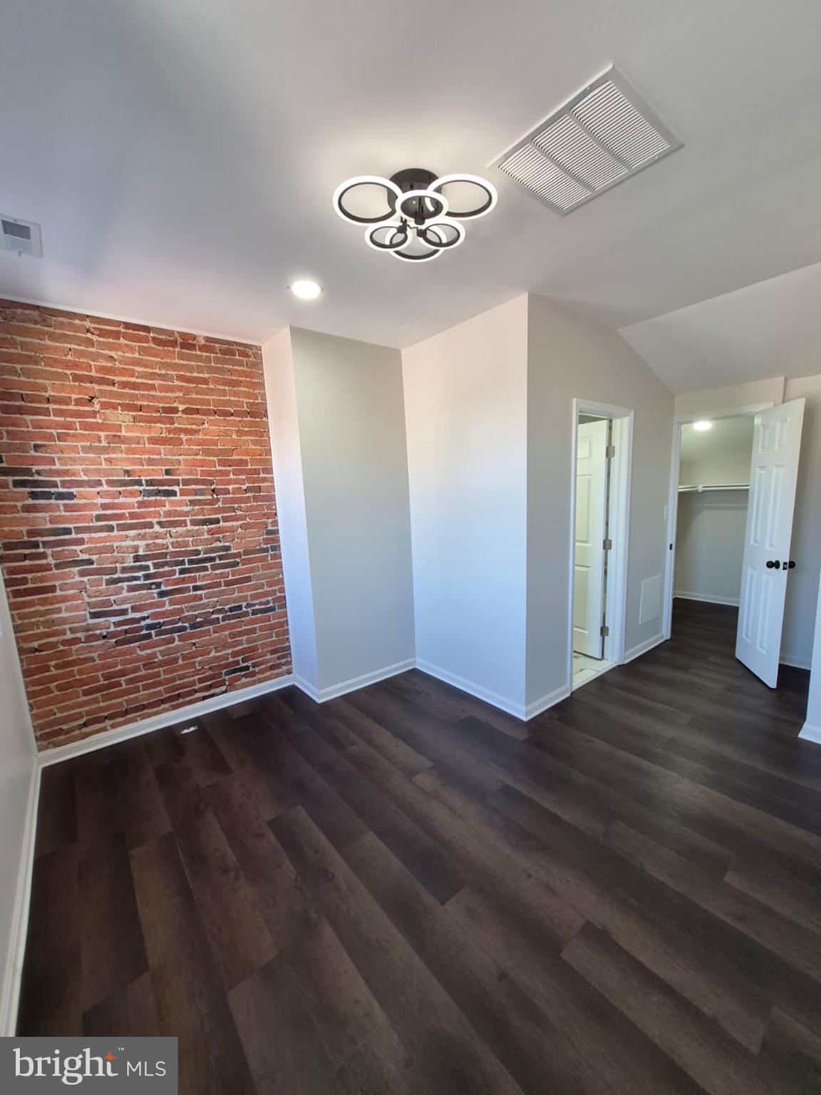 2015 East Fairmount Avenue Baltimore, MD 21231 - Photo 19 of 27 a view of an empty room with wooden floor and a ceiling fan