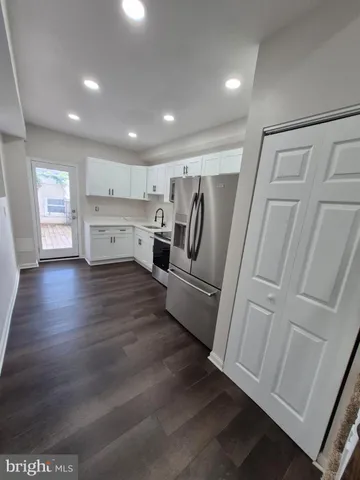 a view of kitchen with furniture and wooden floor