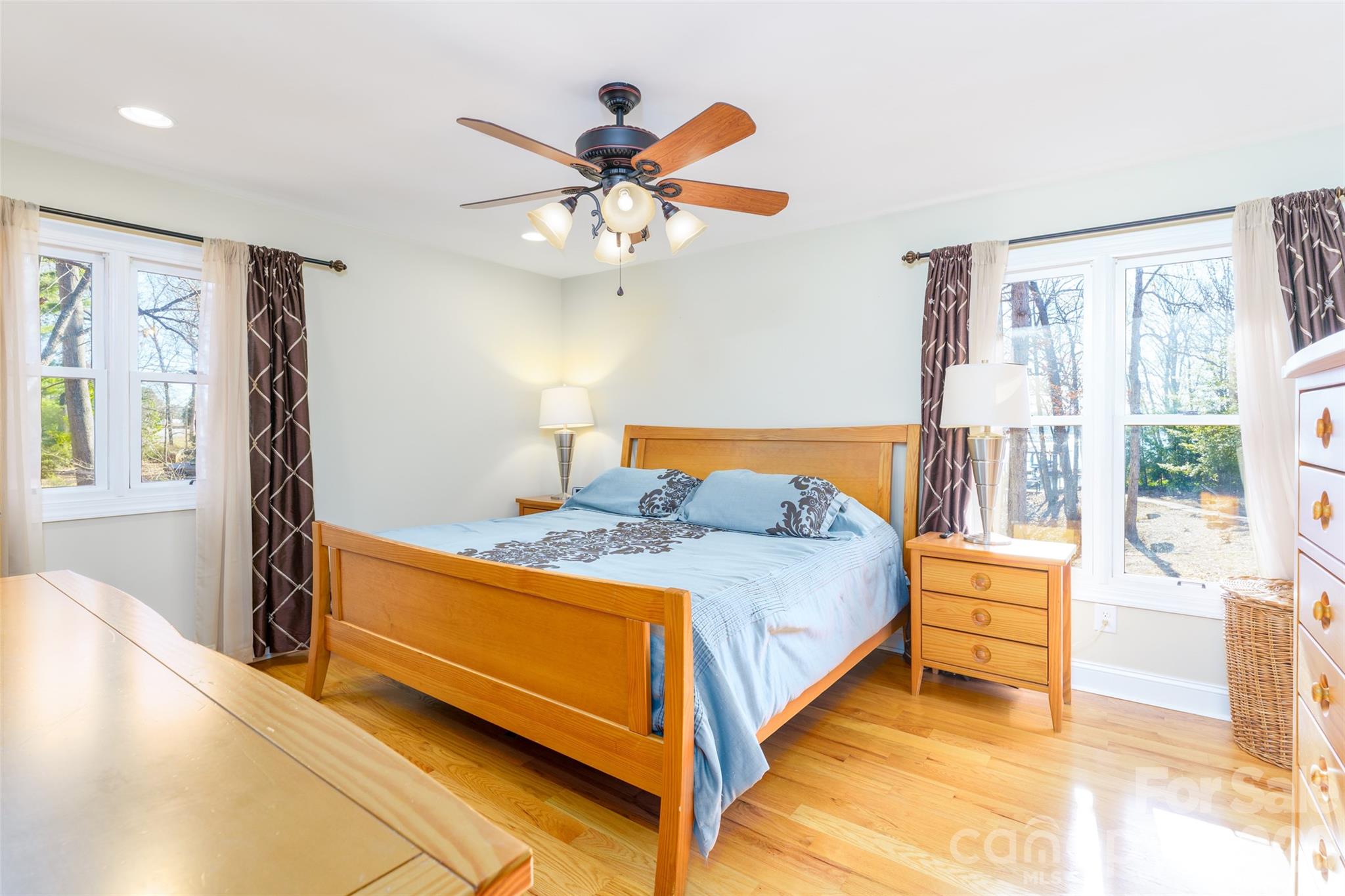 8194 Mallard Road Denver, NC 28037 - Photo 12 of 48 a bedroom with a bed and a chandelier