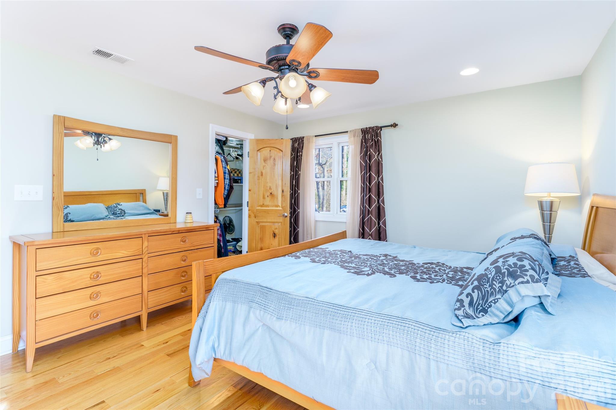 8194 Mallard Road Denver, NC 28037 - Photo 13 of 48 a bedroom with a bed and a chandelier