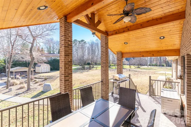 a view of a balcony with furniture and a floor to ceiling window