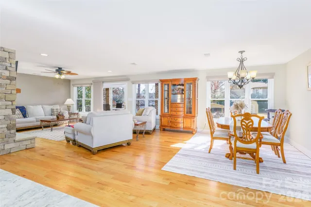 a living room with furniture and a dining table