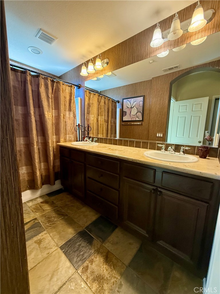 44965 Blue Rosemary Way Temecula, CA 92592 - Photo 12 of 25 a bathroom with a sink and a mirror