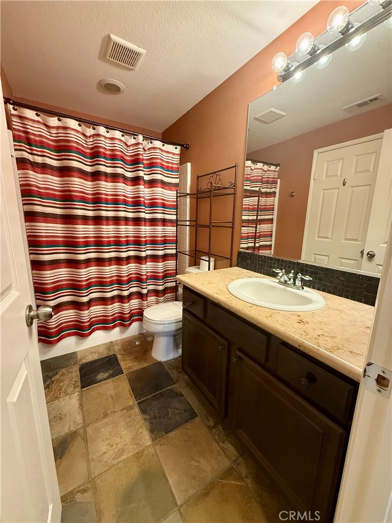44965 Blue Rosemary Way Temecula, CA 92592 - Photo 14 of 25 a bathroom with a sink and a mirror